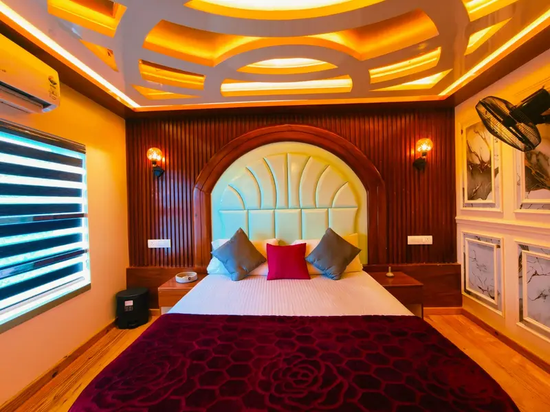 Deluxe AC bedroom with arched headboard